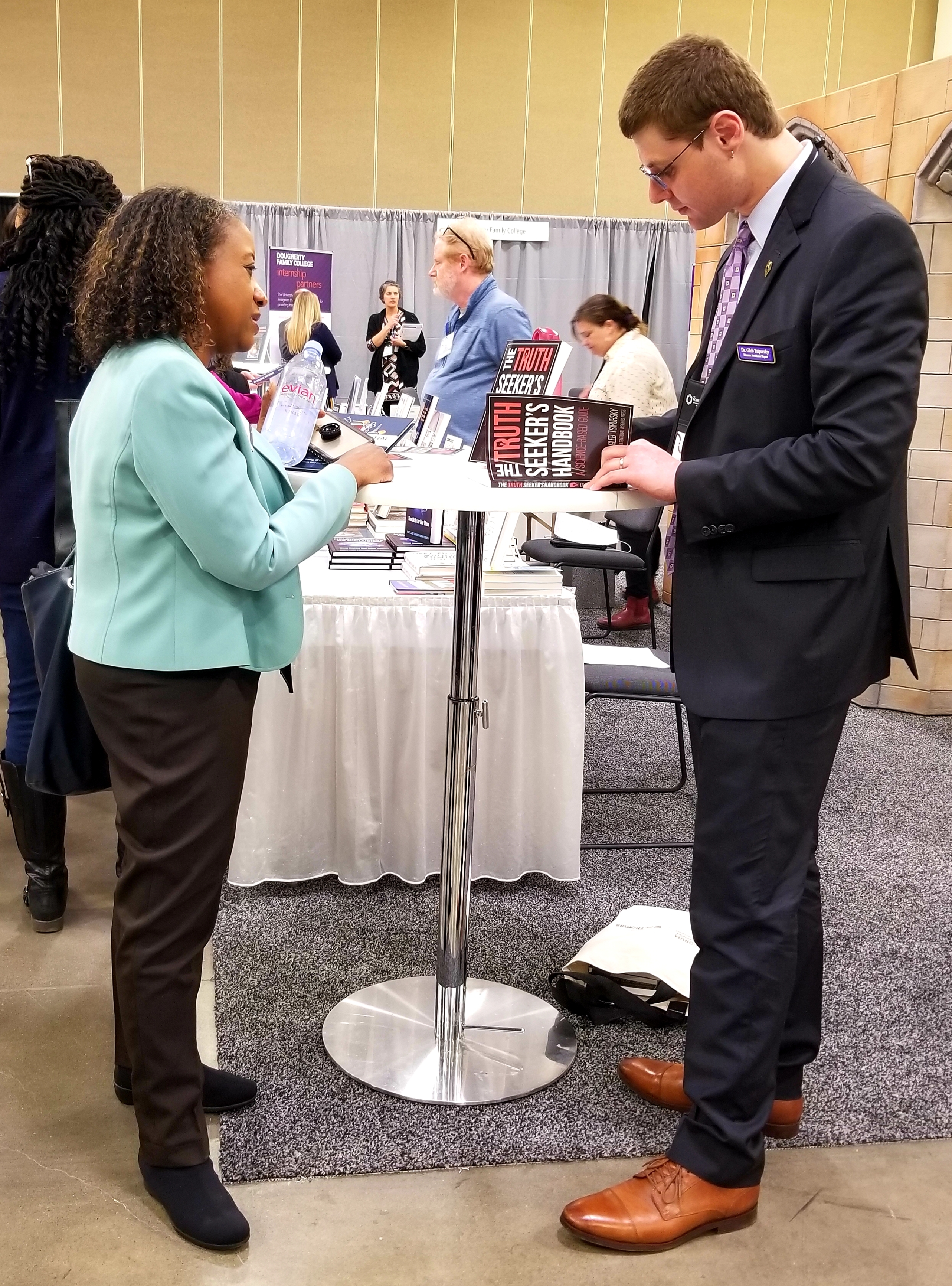 photo of Dr. Tsipursky signing his book for an event guest